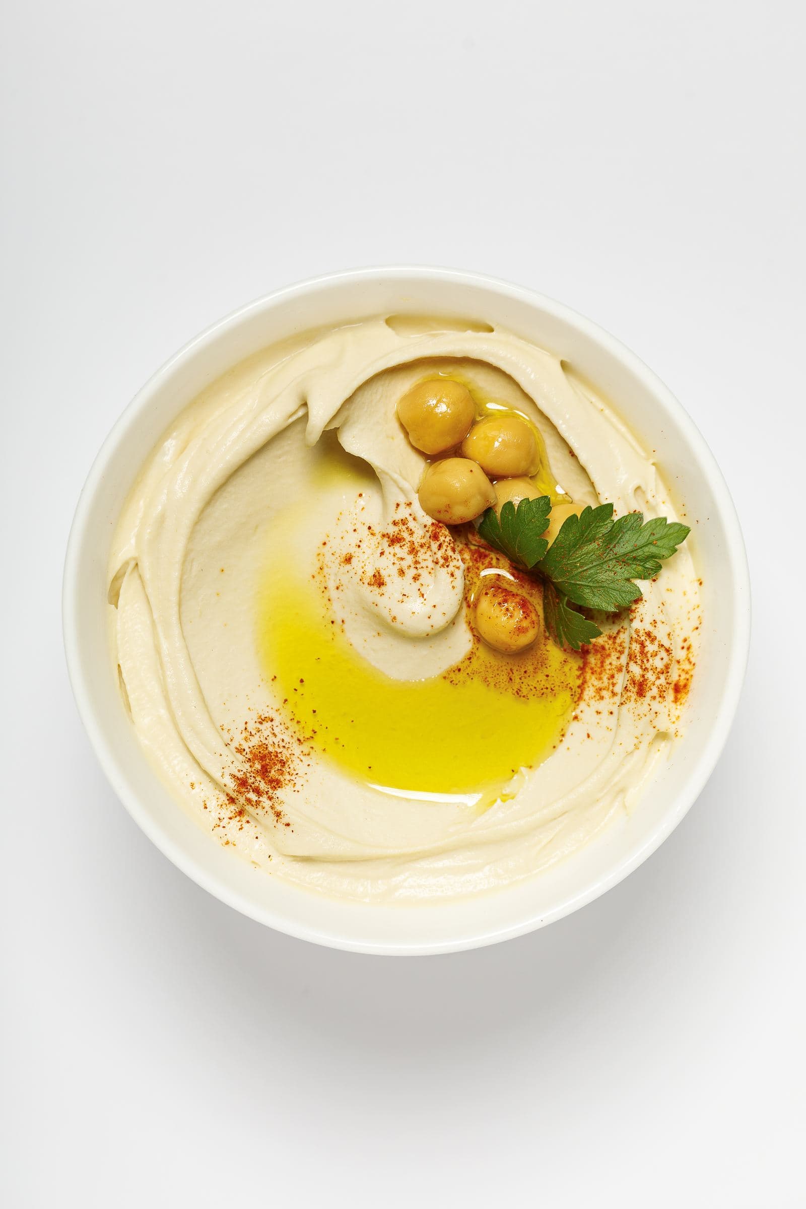 Bowl of Smart Gourmet Classic Hummus with chickpeas, olive oil, paprika and parsley