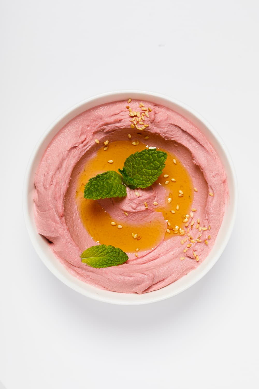 Bowl of pink Smart Gourmet Beetroot Hummus with mint and sesame