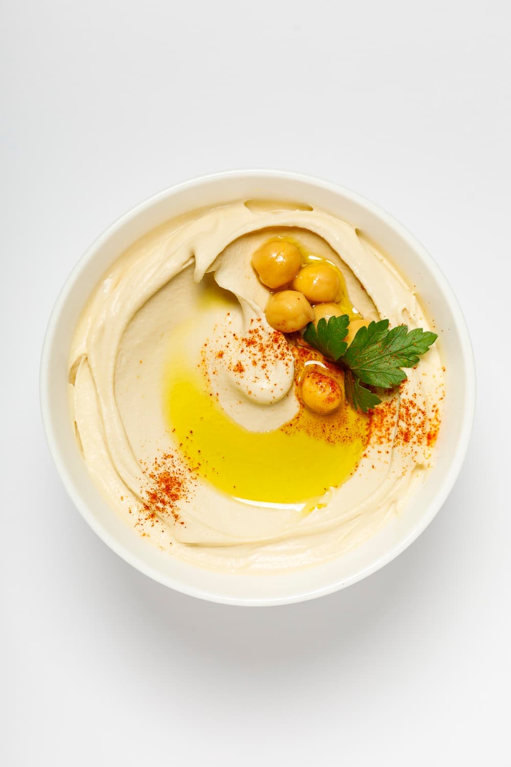 Bowl of Smart Gourmet Classic Hummus with chickpeas, olive oil and parsley