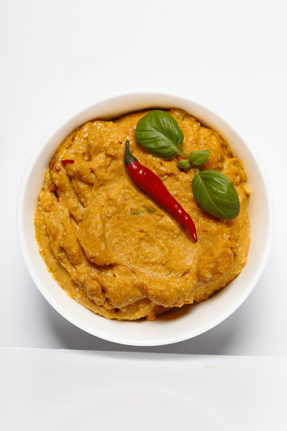 Bowl of Smart Gourmet Pepper Basil Toum with basil and peppercorns
